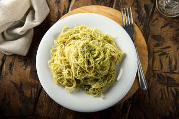 Spaghetti with pesto sauce and cheese