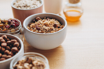 a delicious and crunchy oatmeal granola with honey, nuts, dried fruits and grains. Dynamic healthy food photography