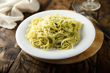 Spaghetti with pesto sauce and cheese