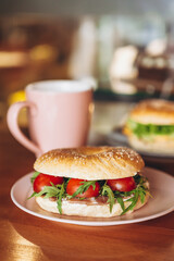 delicious and appetizing breakfast: a bagel stuffed on a plate