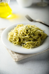 Spaghetti with pesto sauce and cheese