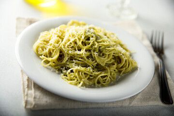 Spaghetti with pesto sauce and cheese