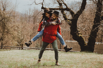 Loving couple walking on the mountain outdoors. Man and woman travel together. Couple traveler enjoys nature, hugs,