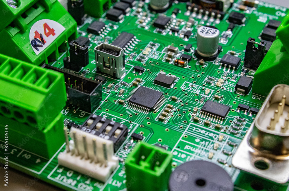 Wall mural green circuitboard with microcontroller in centre of small city