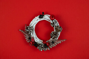 New Year's decorative wreath on a red background. Top view