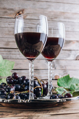 Glasses of red wine with grape.