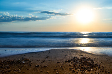 Sea sunset. Quiet calm sea. Sand beach.