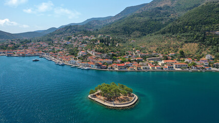 Fototapeta na wymiar Aerial drone photo of picturesque village capital and port of Ithaki or Ithaca island a safe anchoring for sail boats featuring small islet of Lazareto with small chapel built on it, Ionian, Greece