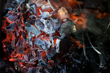 Charcoal on the background of fire close-up.