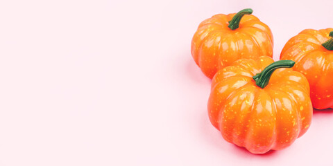 Pink background with pumpkins. Copy space for your text.