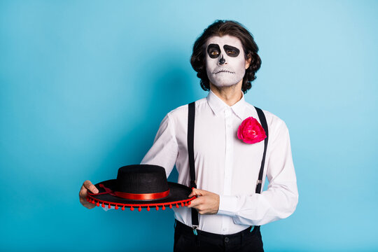Portrait of his he handsome creepy sppoky elegant classy imposing gentleman holding in hands sombrero preparing festal event occasion isolated bright vivid shine vibrant blue color background