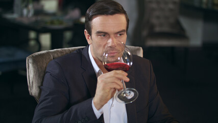 Business man eating food and drinking wine in restaurant. Businessman dining