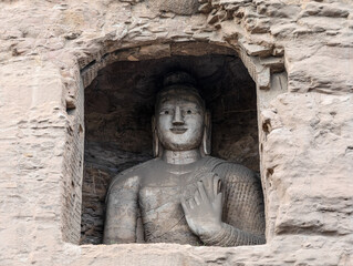 Big Standing statue of Amitabha Buddha in Cave 19 at Yungang Grottoes, Datong, Shanxi, China. Created by Monk Tan Yao in 5th century during Northern Wei period. UNESCO World Heritage.