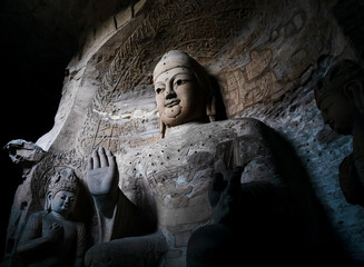 Seated statue of Amitabha Buddha in Cave 3 at Yungang Grottoes, Datong, Shanxi, China. Created from 5th century during Northern Wei period. UNESCO World Heritage.