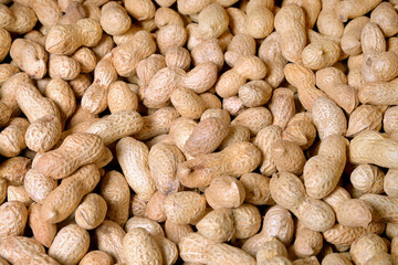 A scattering of peanuts as a very effective and beautiful background of natural products.