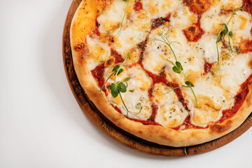 Italian pizza on a white background. Top view close-up. Copyspace.