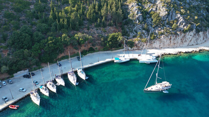 Aerial drone top down photo of sail boats anchored in small port of Frikes, Ithaki or Ithaca island, Ionian, Greece