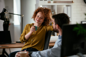 Colleagues in office. Businesswoman and businessman discussing work while drinking coffee...Colleagues in office. Businesswoman and businessman discussing work while drinking coffee...