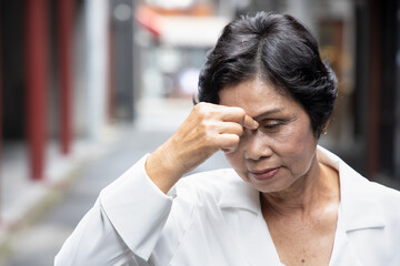 sick asian senior woman suffering from headache; health and sickness concept for vertigo symptoms,...