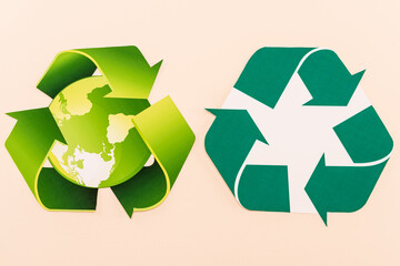 top view of green recycling symbols with planet isolated on beige