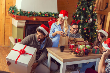 Obraz na płótnie Canvas Friends exchanging presents on Christmas morning