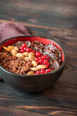 Bowl of red quinoa with nuts and sun-dried tomatoes