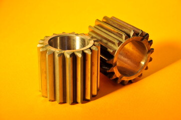 Metal gears on a colored background.