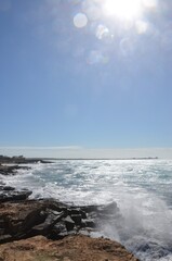Fototapeta premium Mallorca, Spain, rocky coast near the beach Es Trenc in the district of Campos in the South of the Balearic island, creative backlight photo, wavy mediterranean sea, a sunny day 