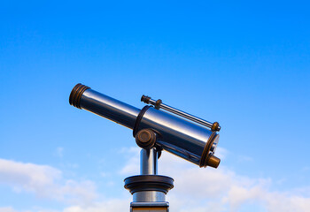 Telescope Looking to the Sky . Touristic binocular telescope looking over the city 