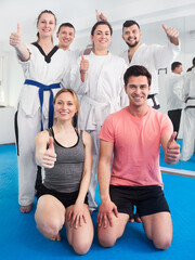Fototapeta na wymiar Young adults happy to attend karate class on self-defense