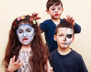 zombie apocalypse kids concept. Birthday party celebration facepaint on children dead bride, scar face, zombie skeleton together closeup makeup emotional posing.