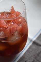 Fresh pink grapefruit, pomelo fruit with iced black tea 