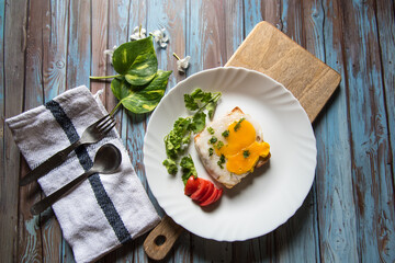 View from top of poached egg on bread with condiments and ingredients on a platter
