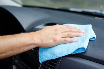 Cleansing car interior. Male hand  disinfecting vihicle