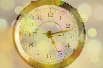 Pocket watch with golden shades with bokeh effect 