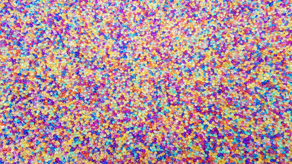 Lots of different colored hydrogel balls. Set of multicolored orbis. Crystal water beads for games. Helium balloons. Can be used as a background. Polymer gel Silica gel.