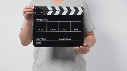 hand is holding clapper board on white background.