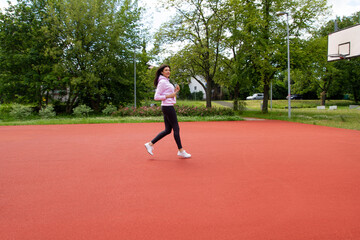 Obraz premium The girl runs on the playground.