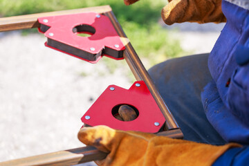 Work tools auxiliary welder worker. Using a magnetic welding angle in work to fix metal