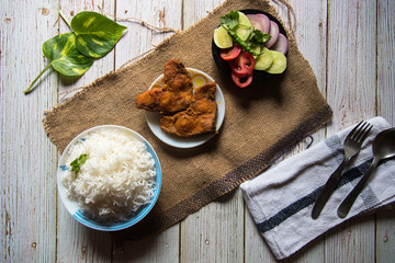 Indian style rice and fried fish with condiments