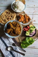Indian meal ready to eat served in bowls and plates on a background