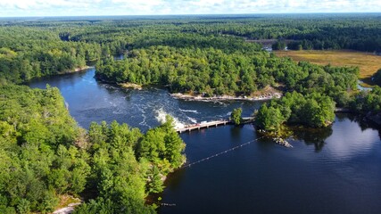 Aerial view on a river with a small dam in Canada