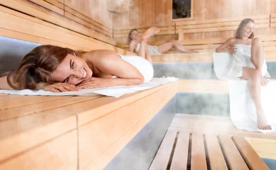 Foto op Canvas Women pursuing healthy lifestyles relaxing in sauna © leszekglasner
