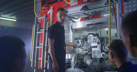 Firefighter teaching trainees on station