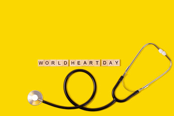 world heart day text with stethoscope on yellow background, health insurance concept, world health day, world heart day concept.