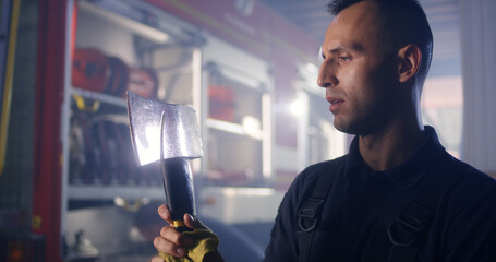 Fireman cleaning axe during work