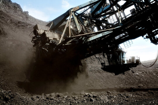 A coal mine in Kazakstan. Black coal and a big machine.