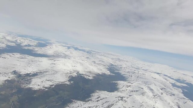 Skydivers over snowy mountains in Norway
