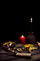 Dark vodun or voodoo ritual table in front of black background, magic and mystical religion
