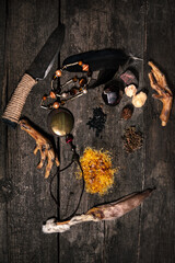 Black or dark ingredients for an ritual, voodoo or occultims materials on wooden table